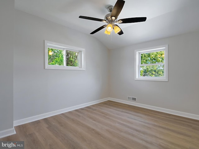 7907 Wallace Rd, Dundalk, MD 21222 - empty room featuring healthy amount of natural light, lofted ceiling, wood finished floors, baseboards, and a ceiling fan