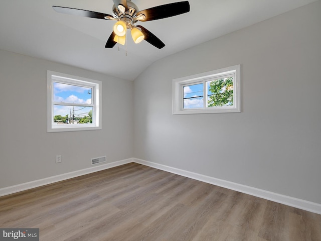 7907 Wallace Rd, Dundalk, MD 21222 - unfurnished room with plenty of natural light, lofted ceiling, wood finished floors, baseboards, and a ceiling fan