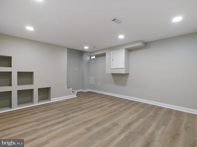 7907 Wallace Rd, Dundalk, MD 21222 - finished below grade area with light wood-style flooring, stairs, recessed lighting, and baseboards