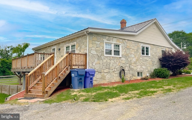 6165 Hawthorne Rd, La Plata, MD 20646 - view of side of home featuring stone siding, a chimney, a wooden deck, metal roof, and stairway