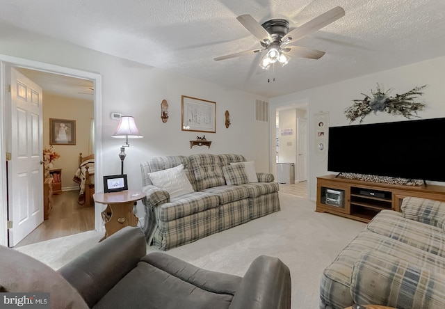 6165 Hawthorne Rd, La Plata, MD 20646 - living room featuring ceiling fan, a textured ceiling, and baseboards