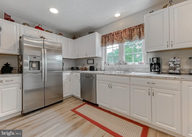 6165 Hawthorne Rd, La Plata, MD 20646 - kitchen with appliances with stainless steel finishes, a sink, white cabinetry, a textured ceiling, and recessed lighting
