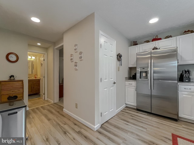 6165 Hawthorne Rd, La Plata, MD 20646 - kitchen featuring stainless steel refrigerator with ice dispenser, white cabinets, light wood-style flooring, recessed lighting, and baseboards