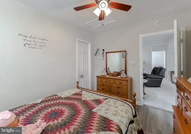 6165 Hawthorne Rd, La Plata, MD 20646 - bedroom with wood finished floors, a textured ceiling, a ceiling fan, and attic access