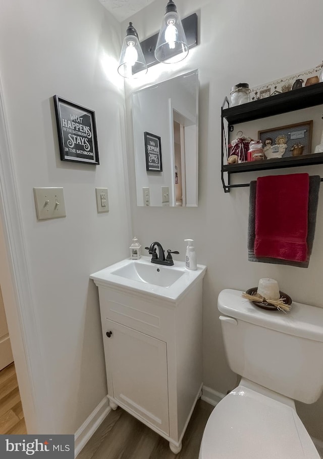 6165 Hawthorne Rd, La Plata, MD 20646 - bathroom featuring vanity, wood finished floors, baseboards, and toilet