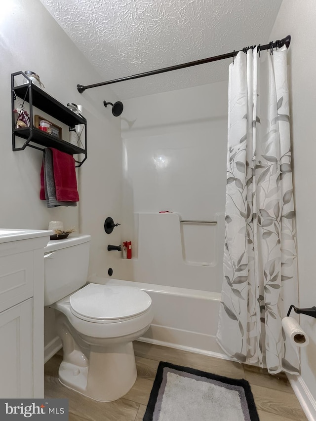 6165 Hawthorne Rd, La Plata, MD 20646 - bathroom featuring shower / bathtub combination with curtain, a textured ceiling, wood finished floors, toilet, and vanity
