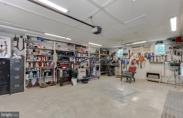 6165 Hawthorne Rd, La Plata, MD 20646 - garage with heating unit, a garage door opener, a workshop area, a wall mounted air conditioner, and a ceiling fan