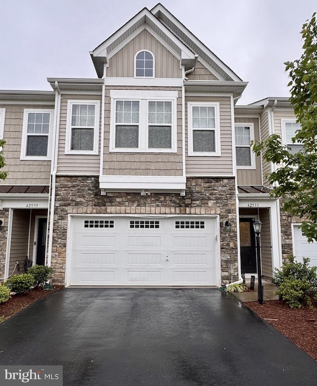 42533 Benfold Sq, Brambleton, VA 20148 - townhome / multi-family property featuring stone siding, driveway, a garage, and board and batten siding