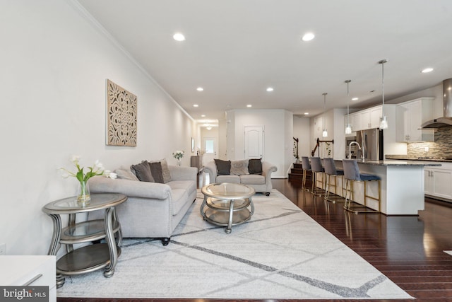 42533 Benfold Sq, Brambleton, VA 20148 - living room featuring dark wood finished floors, recessed lighting, and ornamental molding