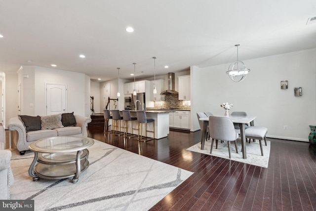 42533 Benfold Sq, Brambleton, VA 20148 - living room with dark wood-type flooring, recessed lighting, ornamental molding, baseboards, and a chandelier