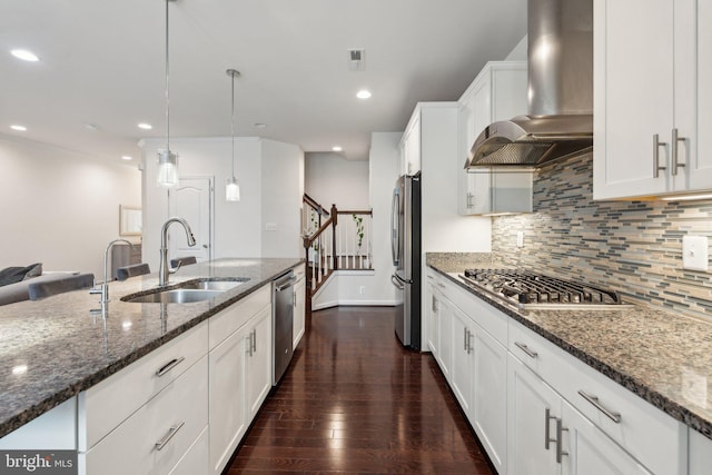 42533 Benfold Sq, Brambleton, VA 20148 - kitchen featuring wall chimney range hood, stainless steel appliances, a sink, backsplash, and white cabinetry