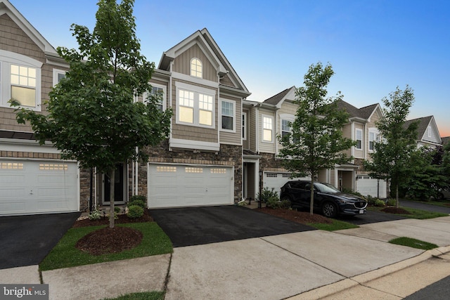 42533 Benfold Sq, Brambleton, VA 20148 - view of property with stone siding, driveway, and a garage