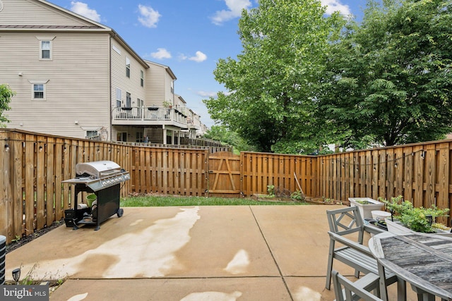 42533 Benfold Sq, Brambleton, VA 20148 - fenced backyard featuring a grill, a patio, a gate, and outdoor dining space