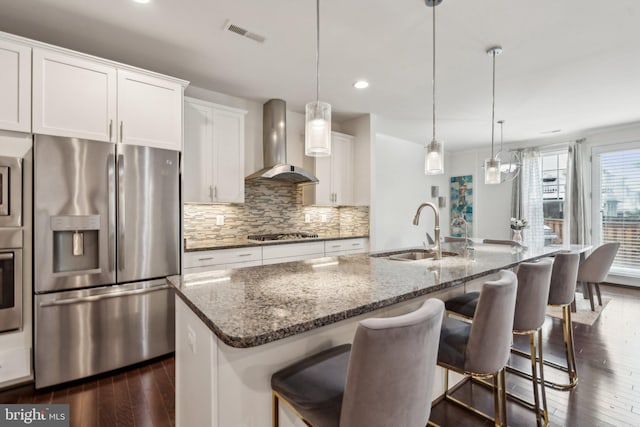 42533 Benfold Sq, Brambleton, VA 20148 - kitchen featuring appliances with stainless steel finishes, wall chimney range hood, a sink, dark wood-style floors, and backsplash