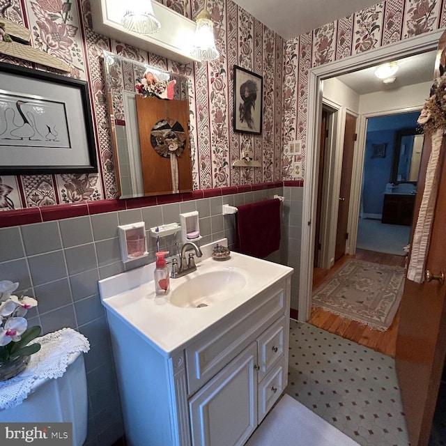 603 Jefferson Blvd, Reading, PA 19609 - bathroom featuring wallpapered walls, wainscoting, vanity, and tile walls