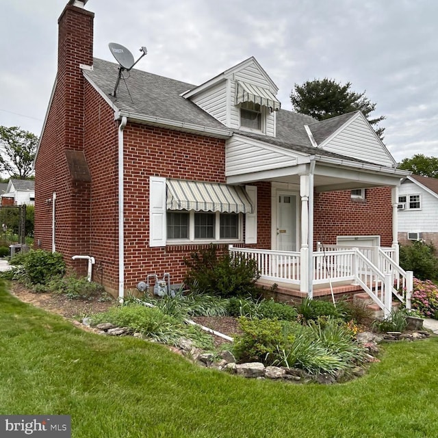 603 Jefferson Blvd, Reading, PA 19609 - bungalow featuring brick siding, a chimney, a front yard, and roof with shingles