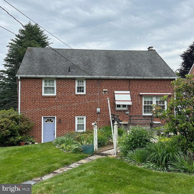 603 Jefferson Blvd, Reading, PA 19609 - view of property exterior featuring a chimney, a lawn, a shingled roof, and brick siding