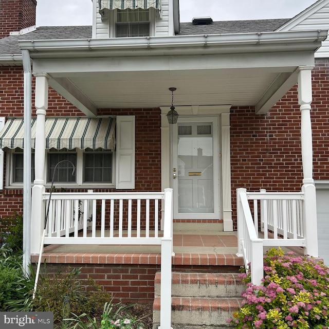 603 Jefferson Blvd, Reading, PA 19609 - entrance to property featuring brick siding, a porch, and roof with shingles