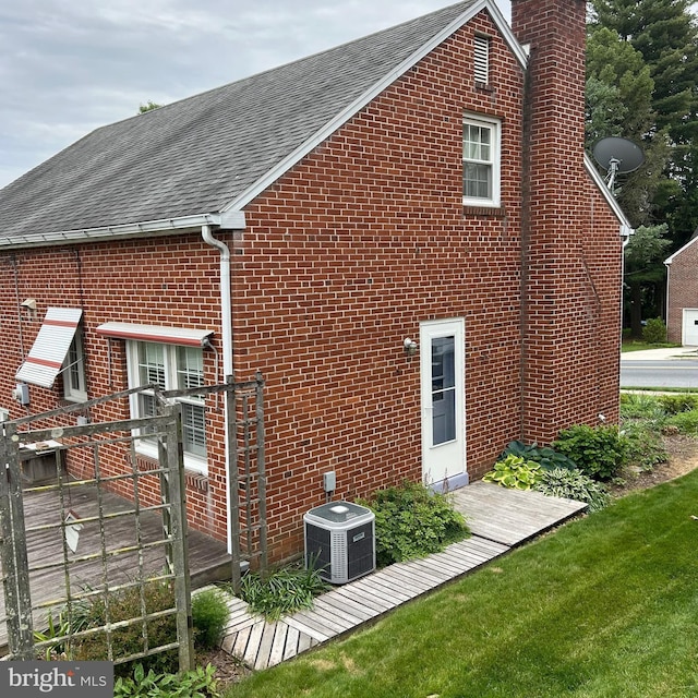 603 Jefferson Blvd, Reading, PA 19609 - view of side of property featuring a chimney, cooling unit, roof with shingles, and brick siding