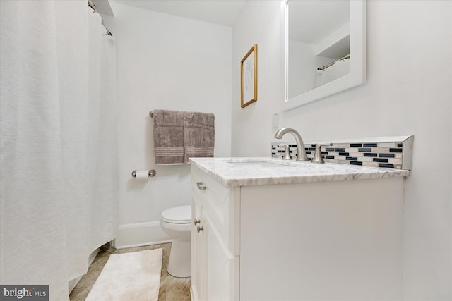 5804 Woodcrest Ave, Baltimore, MD 21215 - full bathroom with vanity, toilet, tasteful backsplash, and baseboards