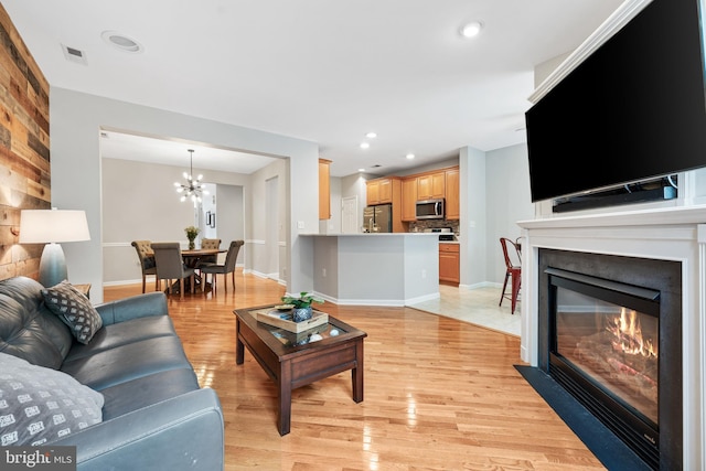 25 Kennedy Ct, Princeton, NJ 08540 - living area featuring a chandelier, light wood-style flooring, a glass covered fireplace, recessed lighting, and baseboards