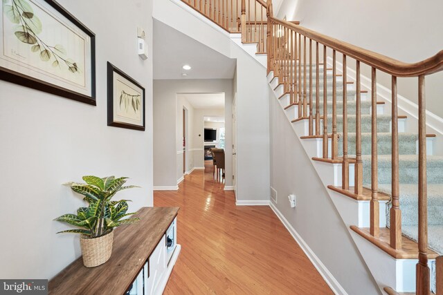 25 Kennedy Ct, Princeton, NJ 08540 - stairway with wood finished floors, baseboards, a high ceiling, and recessed lighting