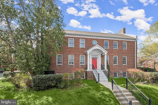 4700 Upton St NW Unit 3, Washington, DC 20016 - colonial inspired home featuring brick siding, a front yard, and a chimney