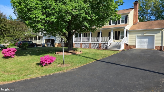3204 Aquia Dr, Stafford, VA 22554 - view of front of property with a garage, a porch, driveway, a chimney, and a front lawn