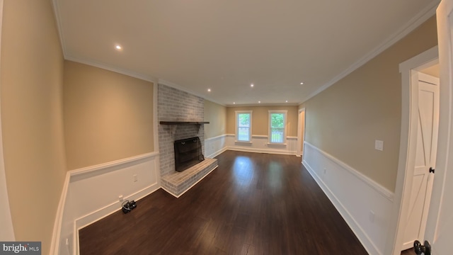 3204 Aquia Dr, Stafford, VA 22554 - unfurnished living room featuring dark wood-style flooring, crown molding, a brick fireplace, recessed lighting, and baseboards