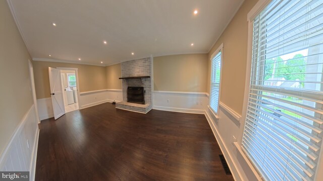 3204 Aquia Dr, Stafford, VA 22554 - unfurnished living room featuring dark wood-style floors, wainscoting, a brick fireplace, ornamental molding, and recessed lighting