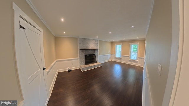 3204 Aquia Dr, Stafford, VA 22554 - unfurnished living room featuring dark wood-style flooring, crown molding, a fireplace, recessed lighting, and a decorative wall