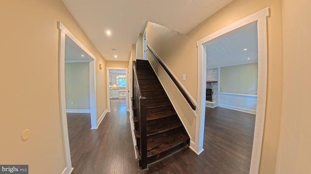 3204 Aquia Dr, Stafford, VA 22554 - staircase featuring wood finished floors, a fireplace, baseboards, and recessed lighting