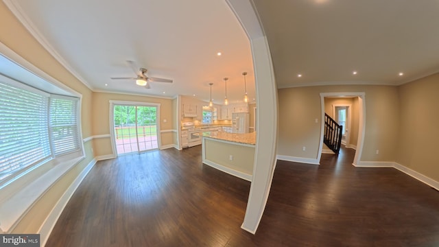 3204 Aquia Dr, Stafford, VA 22554 - unfurnished living room featuring dark wood finished floors, a ceiling fan, baseboards, crown molding, and arched walkways