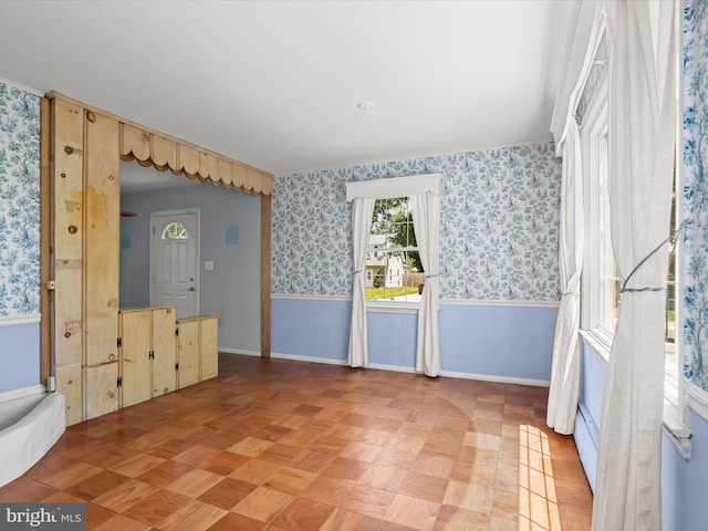 1229 7 Oaks Rd, Halethorpe, MD 21227 - unfurnished room featuring wallpapered walls, baseboards, and a wainscoted wall