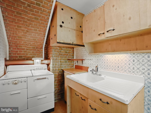 1229 7 Oaks Rd, Halethorpe, MD 21227 - kitchen featuring separate washer and dryer, light brown cabinets, light countertops, a sink, and brick wall