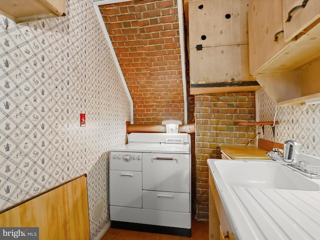 1229 7 Oaks Rd, Halethorpe, MD 21227 - kitchen featuring wallpapered walls, washer and clothes dryer, light countertops, and a sink