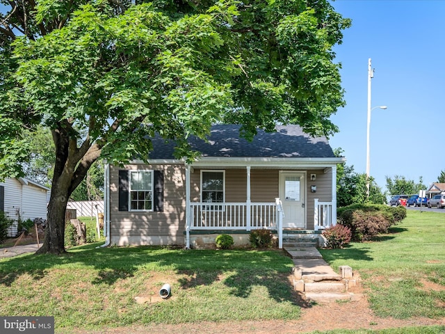 111 S Buchannan St, Ranson, WV 25438 - bungalow featuring covered porch, a front yard, and a shingled roof