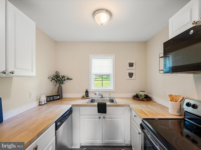 111 S Buchannan St, Ranson, WV 25438 - kitchen featuring stainless steel appliances, a sink, butcher block countertops, and white cabinetry