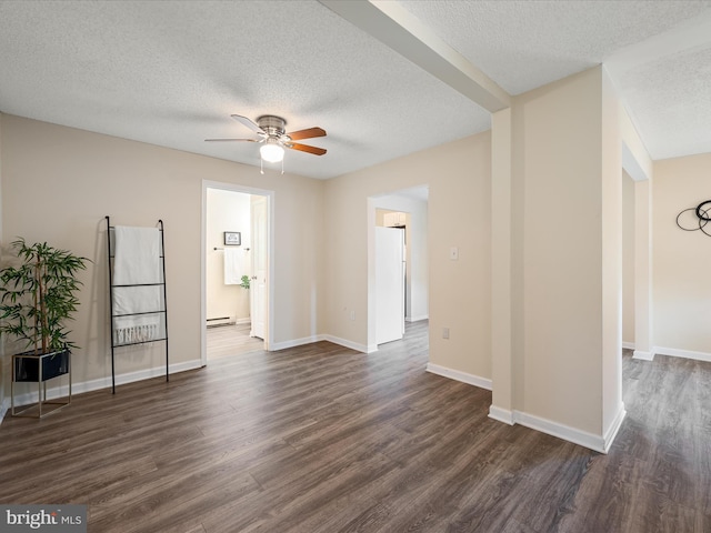111 S Buchannan St, Ranson, WV 25438 - spare room with a textured ceiling, a ceiling fan, dark wood-type flooring, baseboard heating, and baseboards