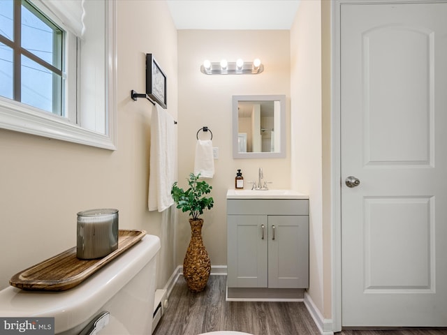 111 S Buchannan St, Ranson, WV 25438 - bathroom with vanity, wood finished floors, and baseboards