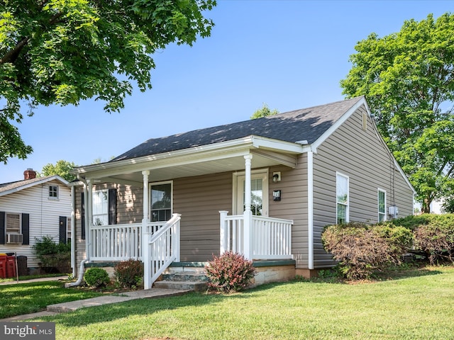 111 S Buchannan St, Ranson, WV 25438 - bungalow-style house featuring a porch, a front yard, cooling unit, and roof with shingles