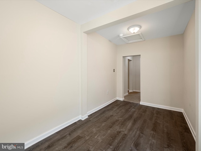 111 S Buchannan St, Ranson, WV 25438 - spare room with dark wood-style flooring, attic access, and baseboards