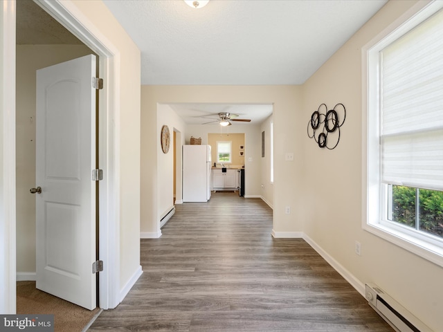 111 S Buchannan St, Ranson, WV 25438 - corridor featuring baseboard heating, plenty of natural light, and wood finished floors