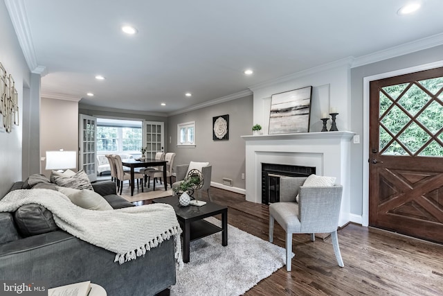 5632 Glenwood Dr, Alexandria, VA 22310 - living room with recessed lighting, dark wood-style flooring, ornamental molding, and a glass covered fireplace