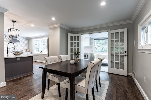 5632 Glenwood Dr, Alexandria, VA 22310 - dining room featuring dark wood-style flooring, crown molding, recessed lighting, and a chandelier