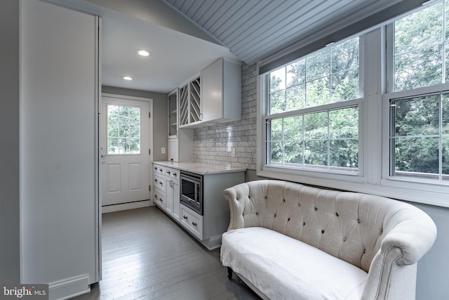 5632 Glenwood Dr, Alexandria, VA 22310 - kitchen featuring stainless steel microwave, lofted ceiling, wood-type flooring, recessed lighting, and decorative backsplash