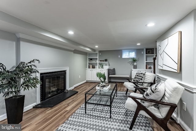 5632 Glenwood Dr, Alexandria, VA 22310 - living area featuring wood finished floors, recessed lighting, a glass covered fireplace, and built in features