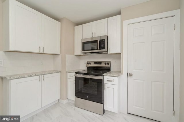 2222 Spruce St, Ewing, NJ 08638 - kitchen with stainless steel appliances, tasteful backsplash, light marble finish flooring, light stone counters, and white cabinets