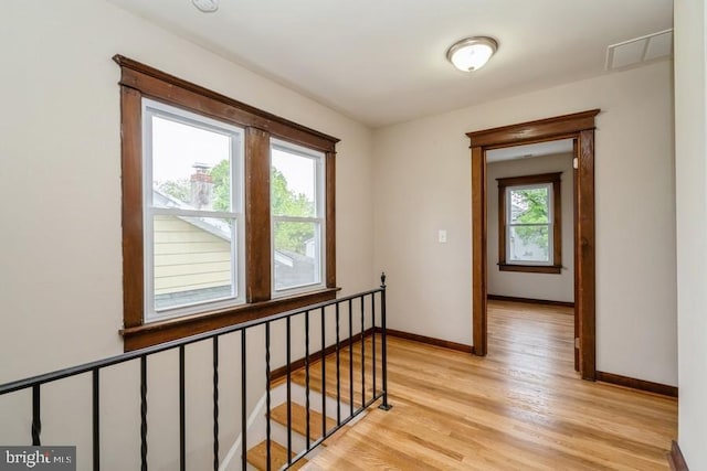 2222 Spruce St, Ewing, NJ 08638 - hall featuring light wood finished floors, baseboards, and an upstairs landing