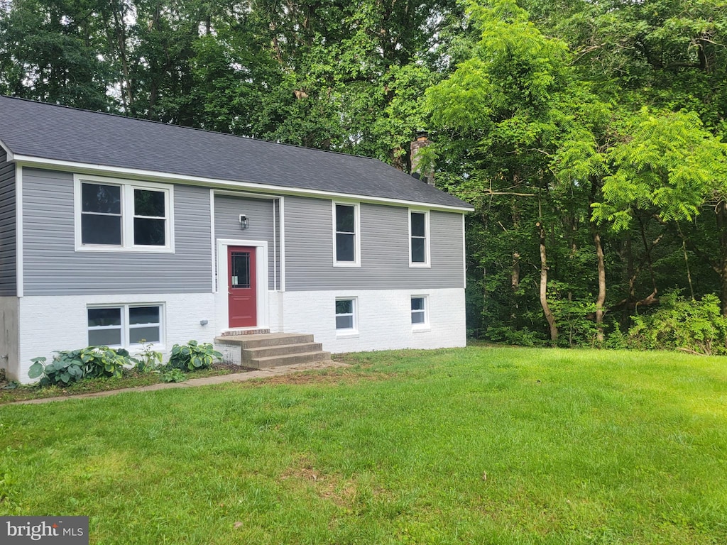 5311 Cove View Dr, Saint Leonard, MD 20685 - split foyer home featuring a front lawn, brick siding, and a shingled roof